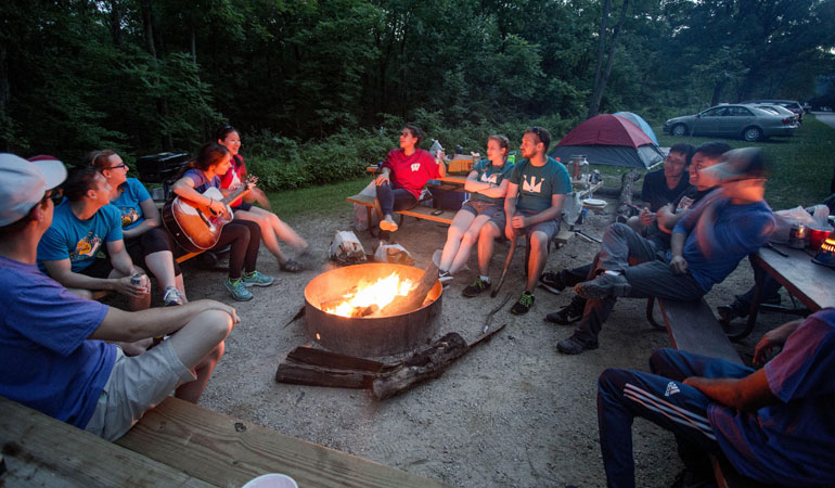 Team bonding around campfire